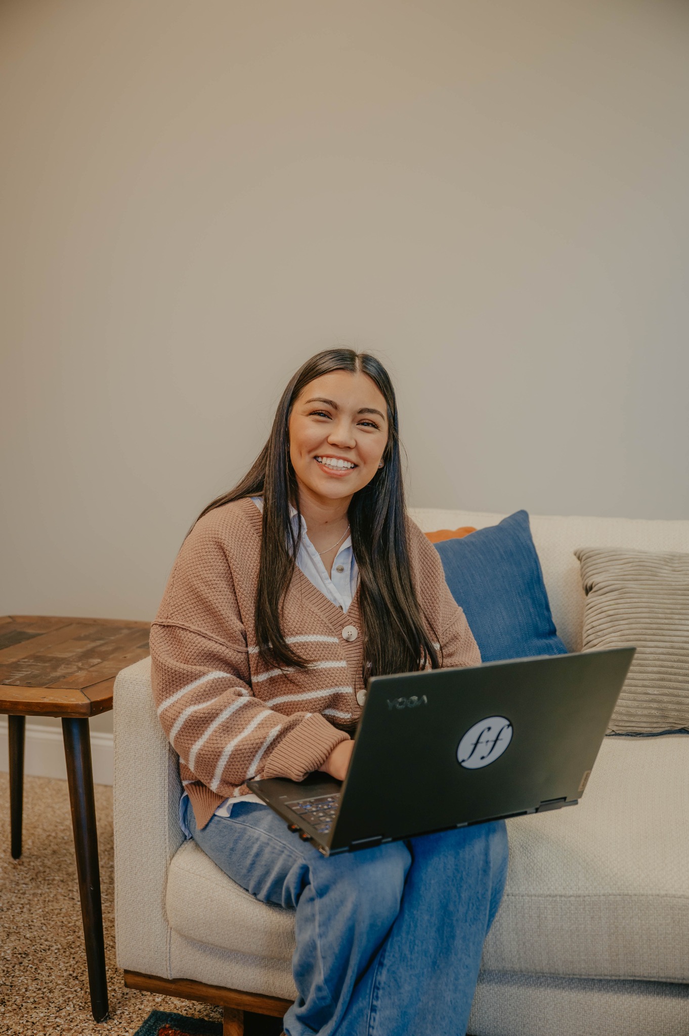 A Faithful Financials team member working on a laptop in a comfortable office setting